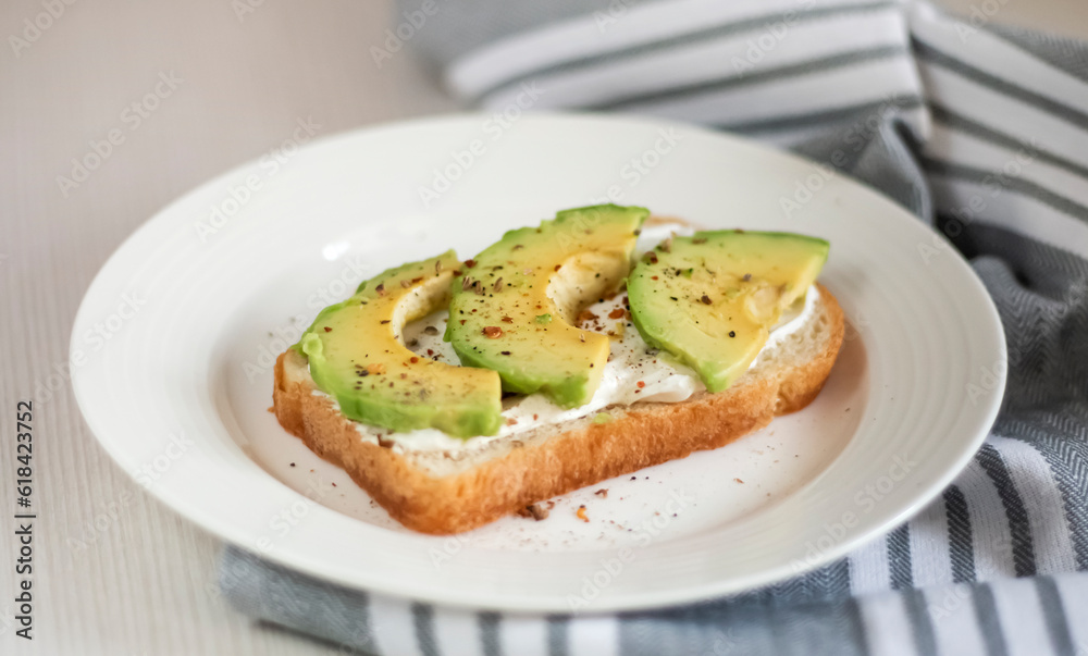 avocado slices on toasted bread with spices in a plate on the table avocado slices on toasted bread with spices in a plate on the table