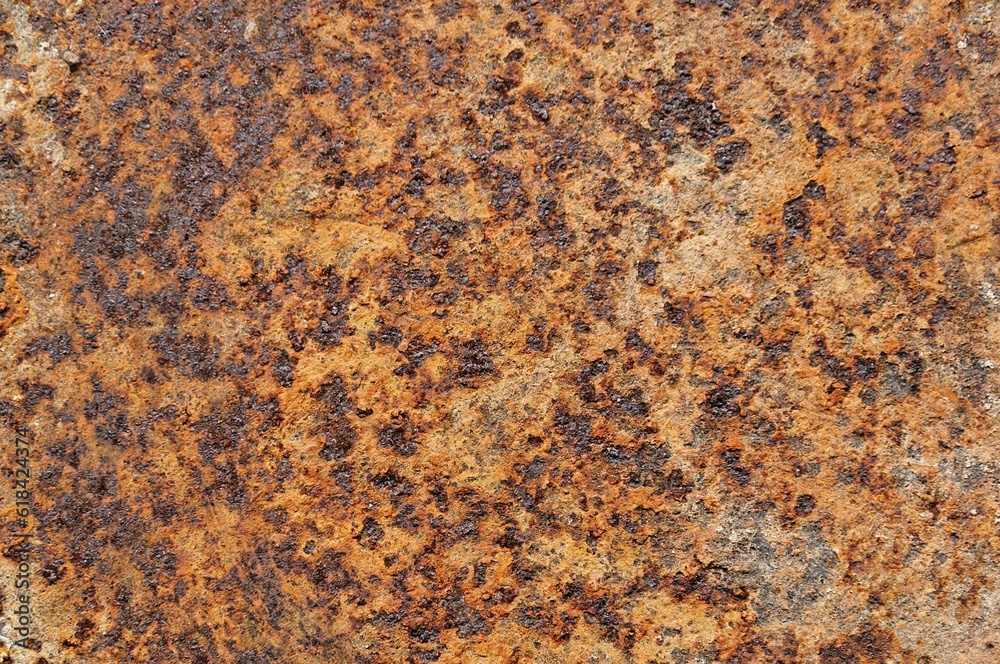 a piece of rusted metal showing brown and black areas a piece of rusted metal showing brown and black areas
