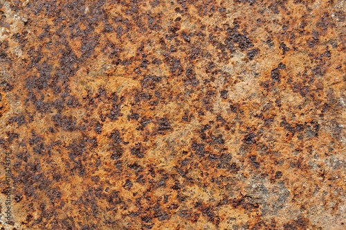 a piece of rusted metal showing brown and black areas
