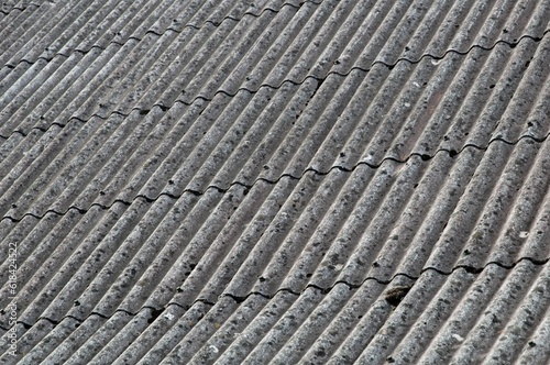 Closeup of a terracotta tiled roof with the texture of the tiles visible © M  Hieber/Wirestock Creators