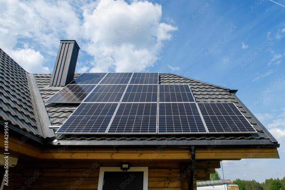Fototapeta premium olar panels on pitched metal roof. Home Renewable Energy Systems. Solar Rooftop System. Photovoltaic Roofing. 