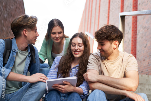 Group of caucasian students studying outside the university campus