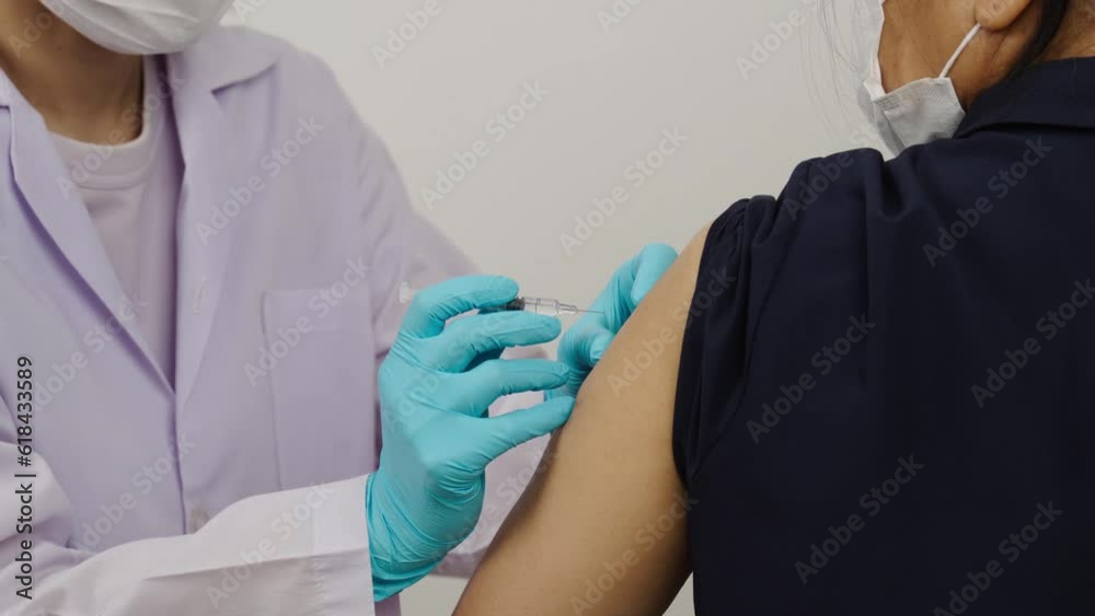 doctor in gloves holding syringe and making injection to patient in medical mask. Covid-19 or coronavirus vaccine doctor in gloves holding syringe and making injection to patient in medical mask. Covid-19 or coronavirus vaccine