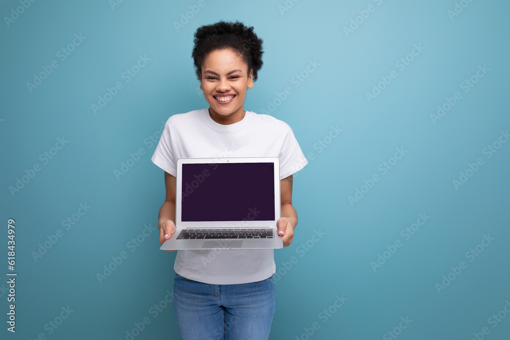young latin brunette student woman in white t-shirt ready to present her project using laptop with mockup
