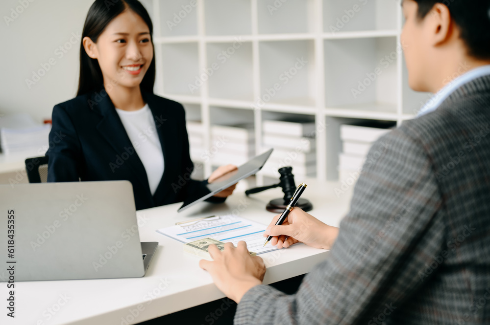 Obraz premium business people and lawyers discussing contract papers sitting at the table. Concepts of law, advice, legal services. in morning light