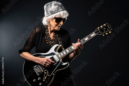 Portrait of a cool trendy old woman playing a guitar on black studio background. Generative AI