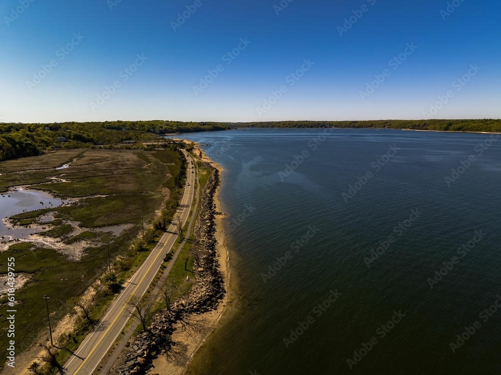 Aerial shot over West Neck Beach on Long Island in the suburb of Lloyd Harbor New York on sunny day