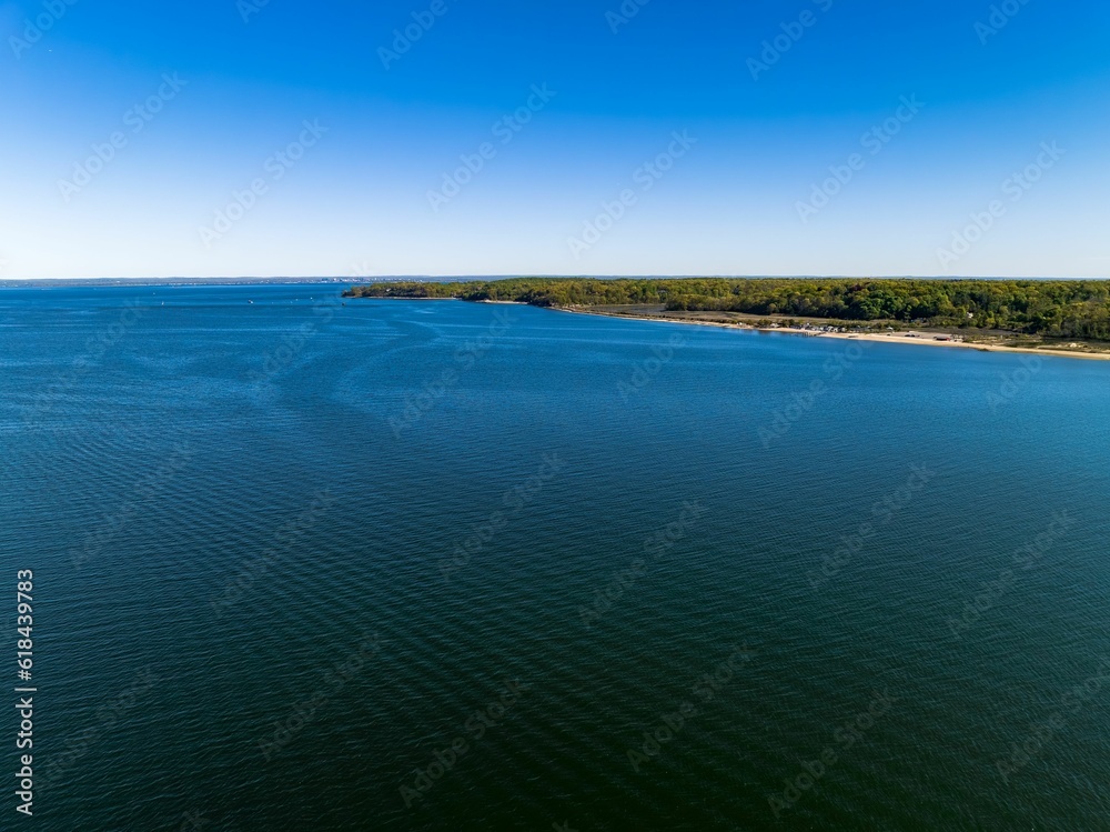 Aerial view over the calm waters in Oyster Bay near Lloyd Harbor, New York on a sunny day