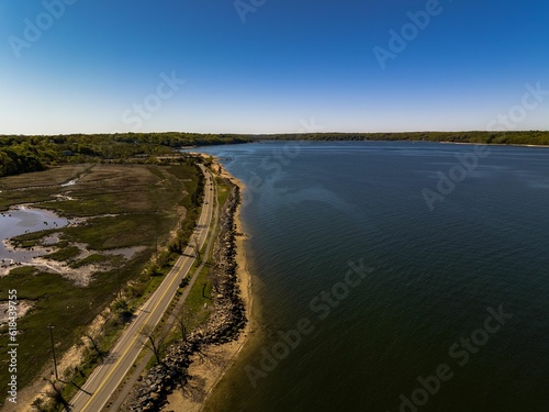 Aerial shot over West Neck Beach on Long Island in the suburb of Lloyd Harbor New York on sunny day © Audley C Bullock/Wirestock Creators