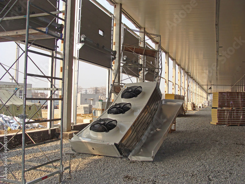 A common case on a construction site. An industrial air conditioner fell from a height to the floor. photo