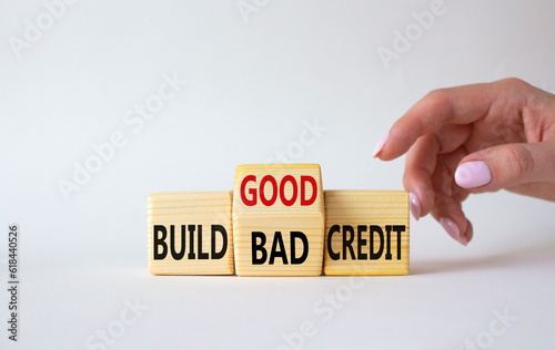 Build Good or Bad Credit symbol. Businessman hand points at wooden cubes with words Build Bad Credit vs Build good credit. Beautiful white background. Business concept. Copy space