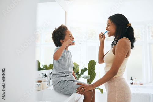 Brushing teeth, hygiene and a mother with her son in the bathroom of their home together for a morning routine. Children, dental and toothbrush with a woman parent teaching her child about oral care