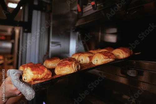 Closeup of freshly baked croissants laid out on a baking tray