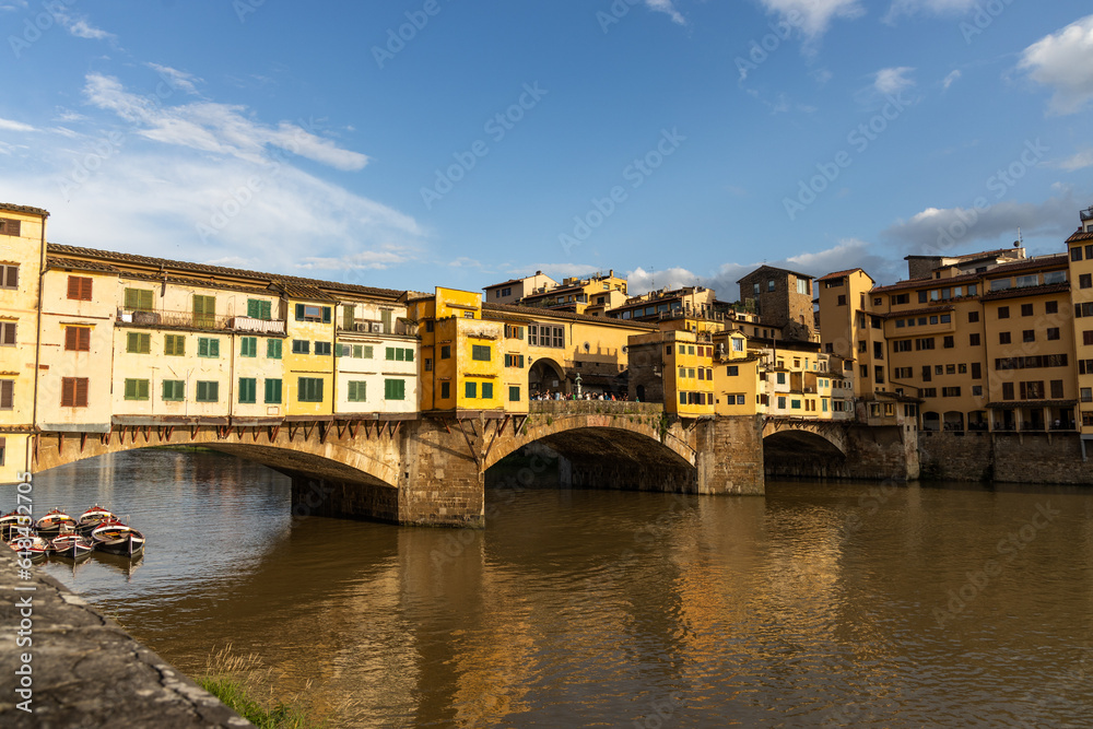 Evening sun over Ponte Vecchio, the historic old bridge over Arno river in Florence, Tuscany, Italy is popular tourist destination