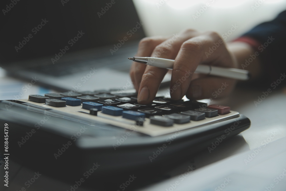Fototapeta premium Unrecognizable businessman using calculator