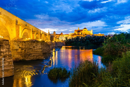 Cordoba, Andalusia, Spain: Twilight view of the old town of Cordoba with the ancient Mosque and Roman Bridge over Guadalquivir river