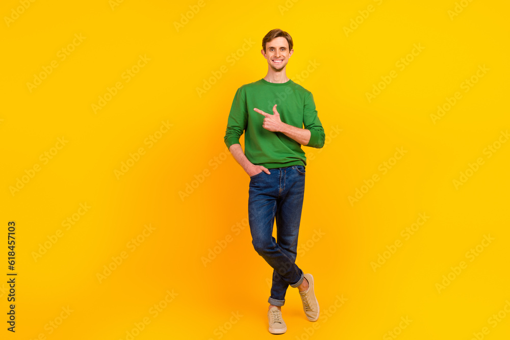Photo of confident promoter guy direct finger suggest empty space wear pullover isolated yellow color background