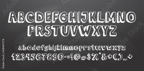 Set of retro hand drawn alphabet letters drawing with white chalk on chalkboard
