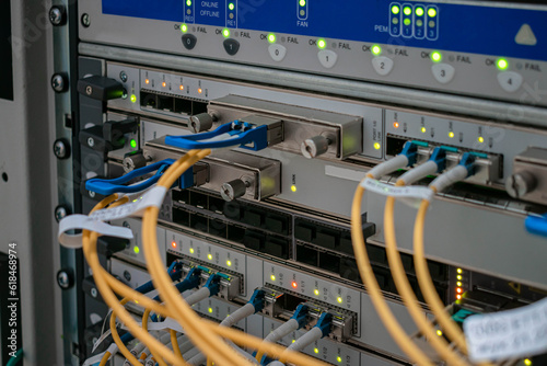 Modern switching equipment is in the server room of the Internet data center. The main fiber optic channels are connected to the interfaces of a powerful router.