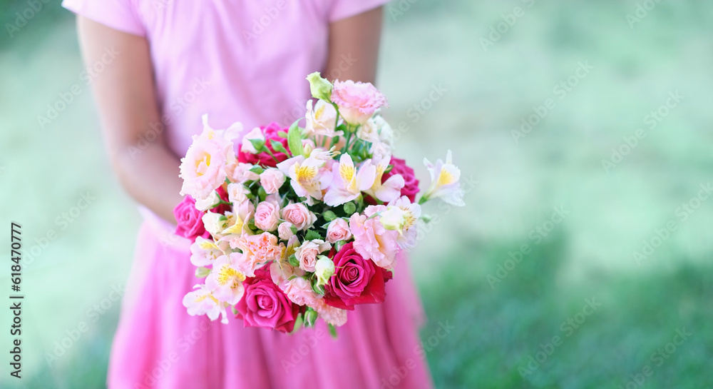 Gentle beautiful floral bouquet in girl hands close up, abstract blurred natural background. romantic floral gift, festive image. copy space. template for design Gentle beautiful floral bouquet in girl hands close up, abstract blurred natural background. romantic floral gift, festive image. copy space. template for design