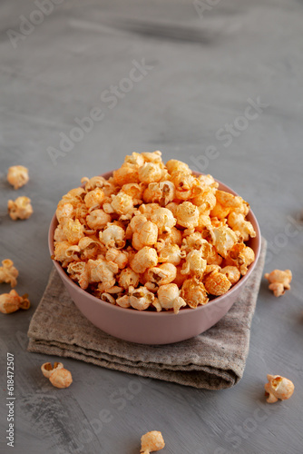 Homemade Cheese Popcorn in a Bowl on a gray background, side view. Copy space.