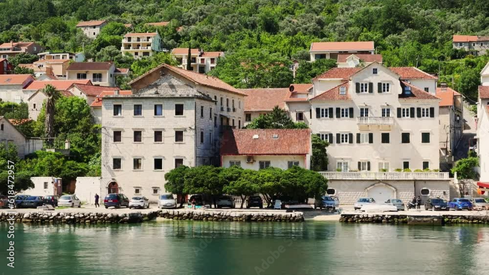 View from sea to shore with old town and cityscape. Trucking left shot. Summer in Montenegro View from sea to shore with old town and cityscape. Trucking left shot. Summer in Montenegro
