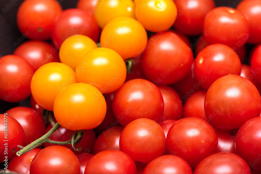 Full frame of red and yellow ripe cherry tomatoes.