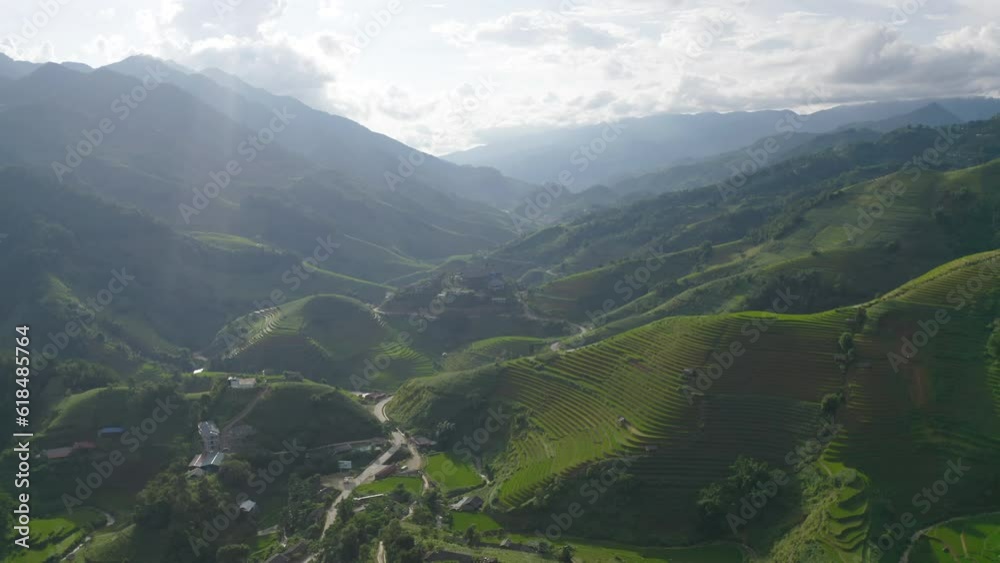Aerial top view of fresh paddy rice terraces, green agricultural fields in countryside or rural area of Mu Cang Chai, mountain hills valley in Asia, Vietnam. Nature landscape background. Aerial top view of fresh paddy rice terraces, green agricultural fields in countryside or rural area of Mu Cang Chai, mountain hills valley in Asia, Vietnam. Nature landscape background.