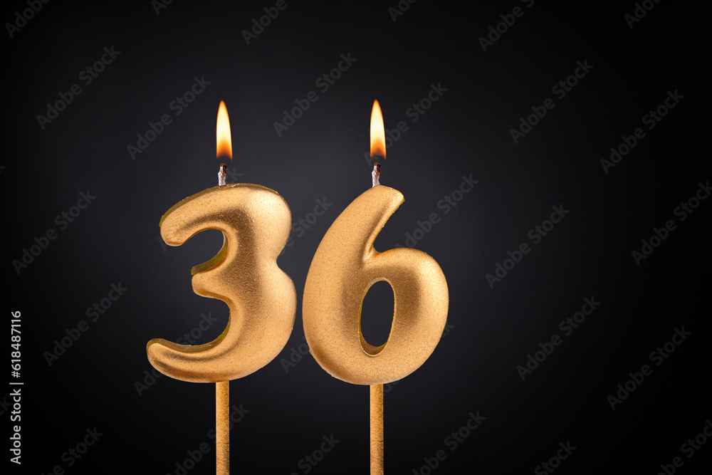 Golden candle 36 with flame - Birthday card on dark luxury background Golden candle 36 with flame - Birthday card on dark luxury background