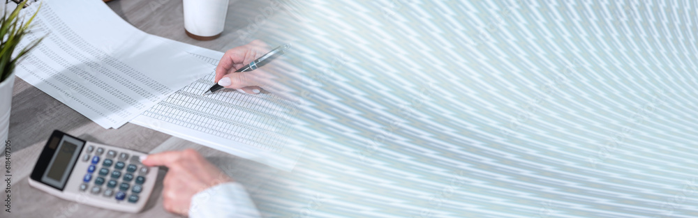 Female hands using calculator; panoramic banner Female hands using calculator; panoramic banner