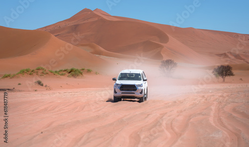 4X4 Suv vehicle rides through the sand dune Namib desert - Namibia