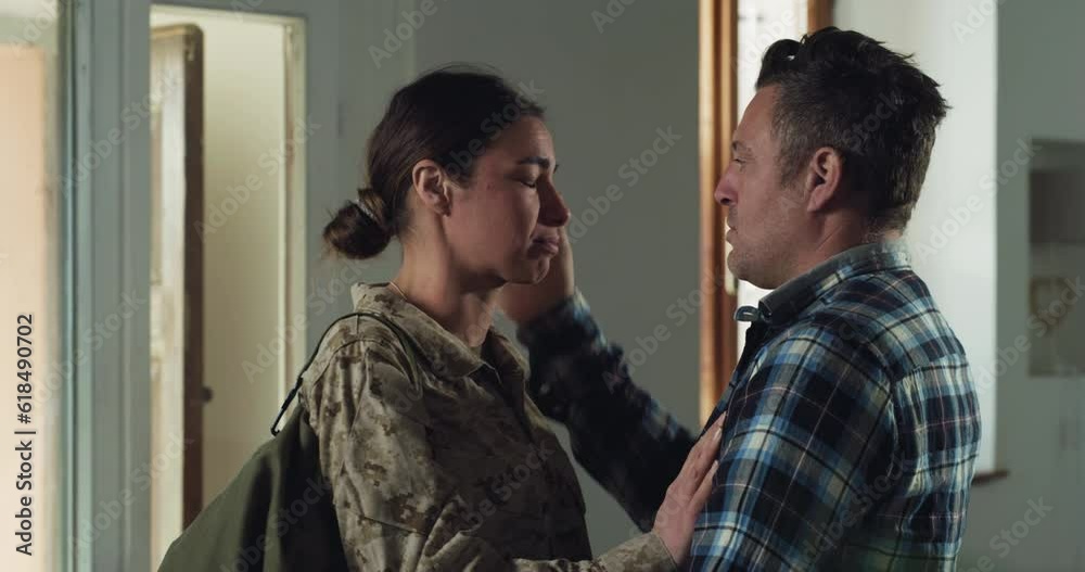 Portrait of Young Female Soldier Hugging and kissing her Husband Before Leaving Home For a Mission. Emotional Wife in Camouflage Military Uniform Saying her Farewells Before Leaving to War, Crying Portrait of Young Female Soldier Hugging and kissing her Husband Before Leaving Home For a Mission. Emotional Wife in Camouflage Military Uniform Saying her Farewells Before Leaving to War, Crying