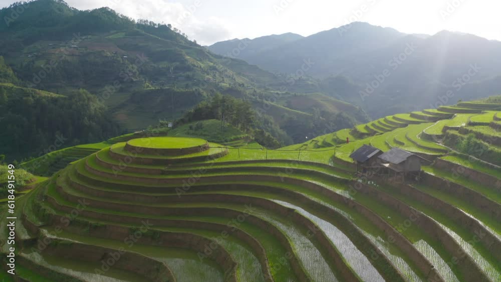 Aerial top view of fresh paddy rice terraces, green agricultural fields in countryside or rural area of Mu Cang Chai, mountain hills valley in Asia, Vietnam. Nature landscape background. Aerial top view of fresh paddy rice terraces, green agricultural fields in countryside or rural area of Mu Cang Chai, mountain hills valley in Asia, Vietnam. Nature landscape background.
