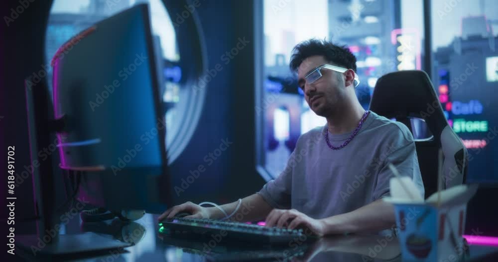 Creative Multiethnic Man Using Desktop Computer in a Futuristic High Tech Office Space. Young Handsome Man Wearing Advanced Device or Augmented Reality Glasses White Working Behind a Desk Creative Multiethnic Man Using Desktop Computer in a Futuristic High Tech Office Space. Young Handsome Man Wearing Advanced Device or Augmented Reality Glasses White Working Behind a Desk