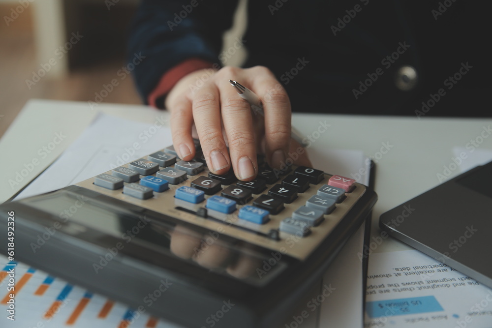 Businessmen are calculating income-expenditure and analyzing real estate investment data, Accounting Financial and tax systems concept. Businessmen are calculating income-expenditure and analyzing real estate investment data, Accounting Financial and tax systems concept.