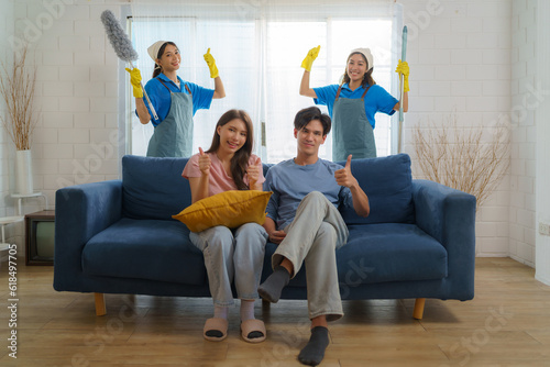 Satisfied Asian homeowner gives a thumbs-up, expressing delight and approval for the exceptional cleaning service provided by the diligent Asian maid photo