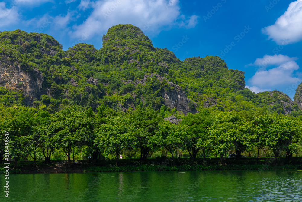 Trang An River Ninh Minh and Bai Dinh Mountain ranges in Vietnam only 3 hours drive from Hanoi. Beautiful winding river and large rising mountains. boats going through the caves in the river