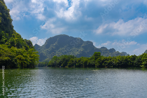Trang An River Ninh Minh and Bai Dinh Mountain ranges in Vietnam only 3 hours drive from Hanoi. Beautiful winding river and large rising mountains. boats going through the caves in the river © Elias Bitar