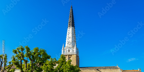 Saint Etienne church and its black and white bell tower in Ars-en-Ré, France photo