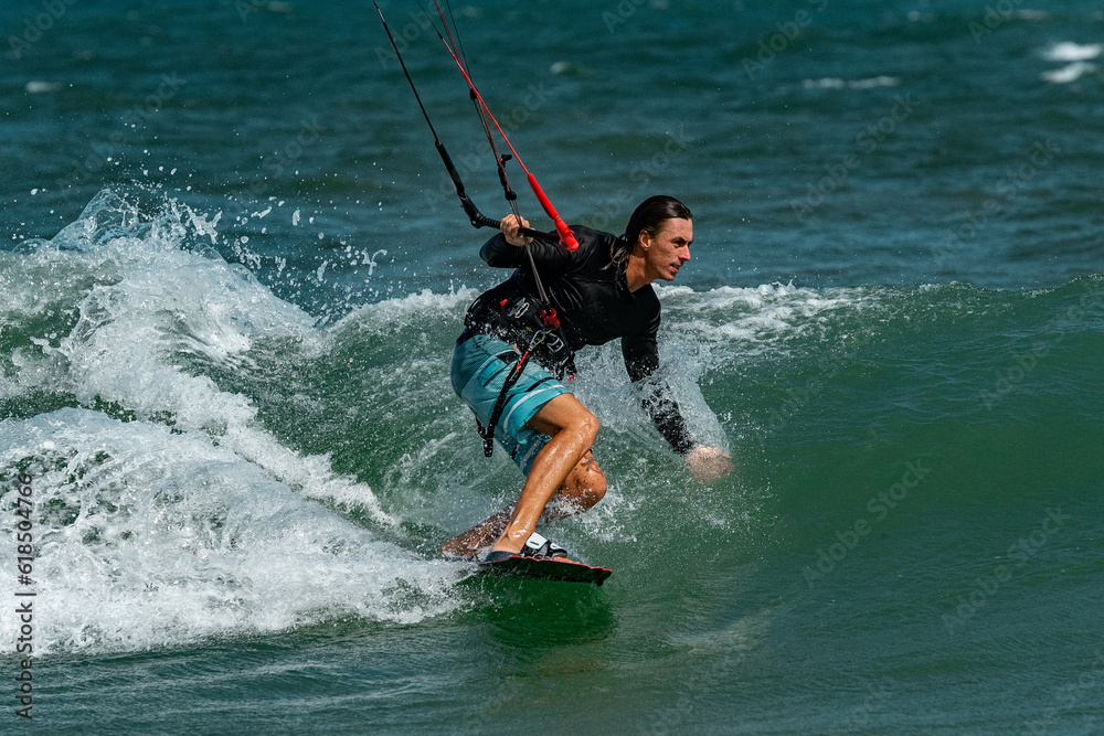 Fototapeta premium A kite surfer rides the waves