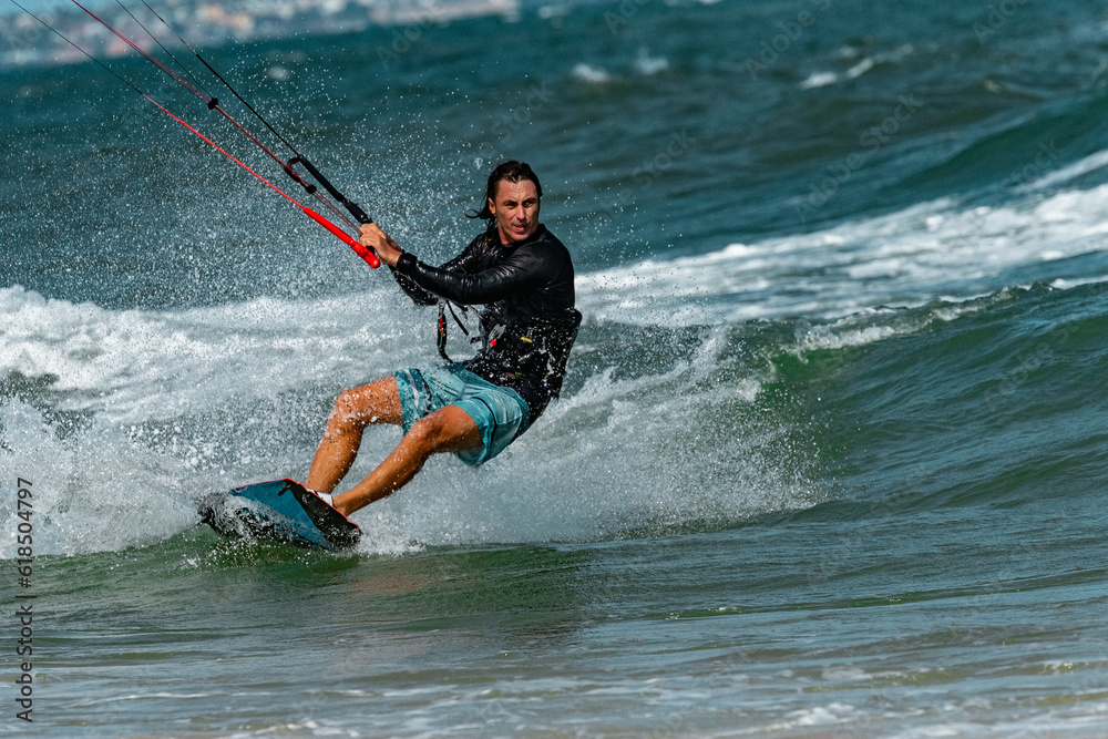 Fototapeta premium A kite surfer rides the waves