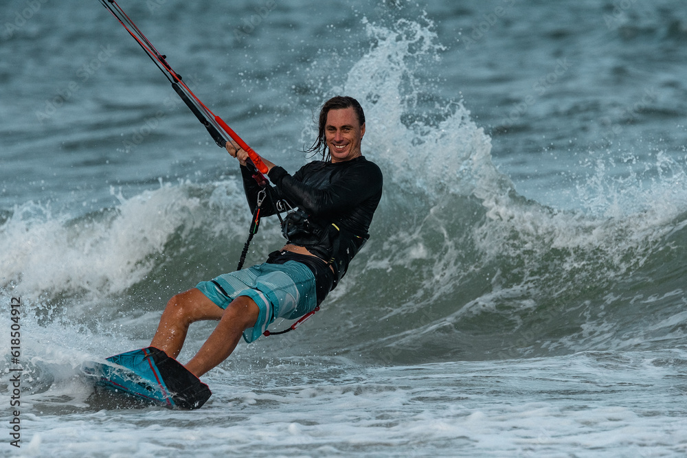 Fototapeta premium A kite surfer rides the waves