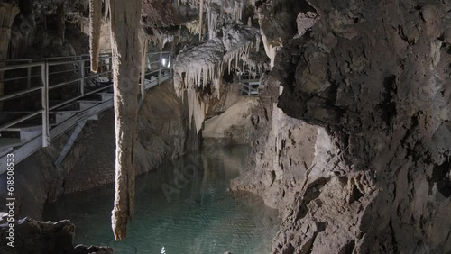 Tourists explore a cave with a beautiful background