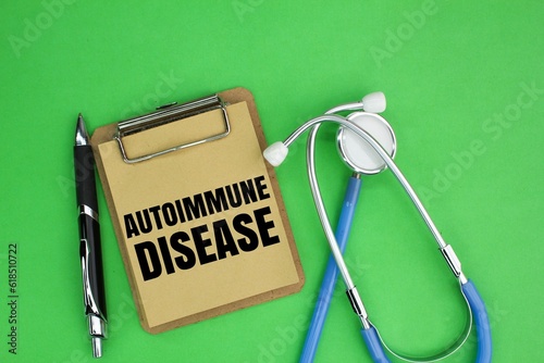 stethoscope, pen and notebook board with the word AUTOIMMUNE DISEASE. medical concept photo