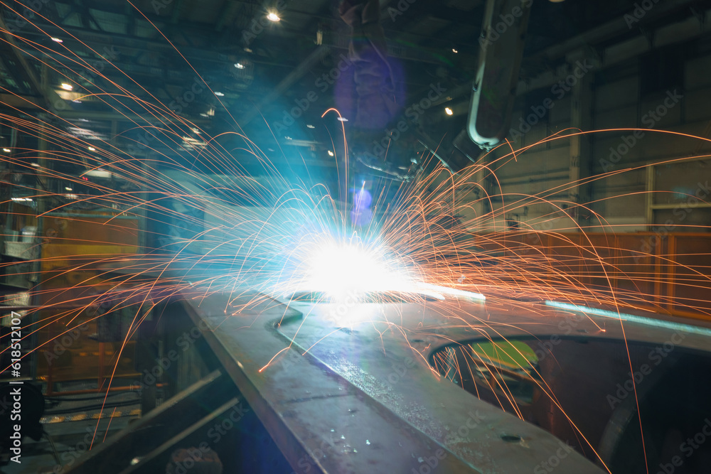 Welding Sparks from robot in manufacturing with blur focus, used is background Welding Sparks from robot in manufacturing with blur focus, used is background
