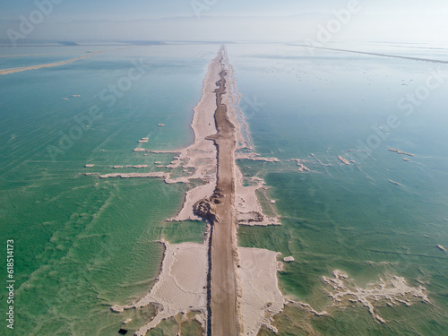 A border between evaporation pools in the dead see from a drone view 