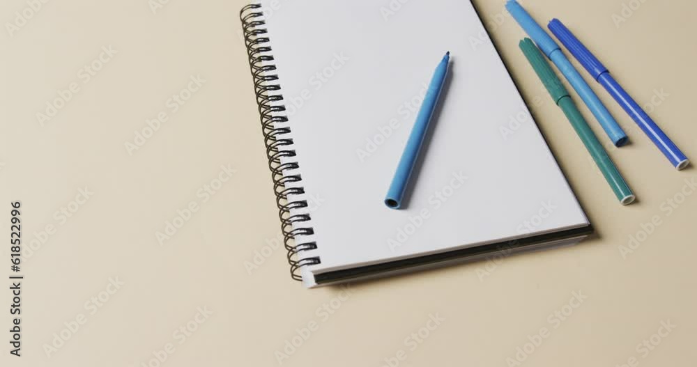 Flat lay of notebook and markers with copy space on yellow background Flat lay of notebook and markers with copy space on yellow background
