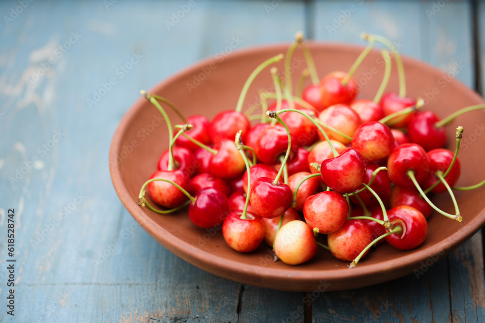 A ripe sweet cherries in a ceramic bowl A ripe sweet cherries in a ceramic bowl
