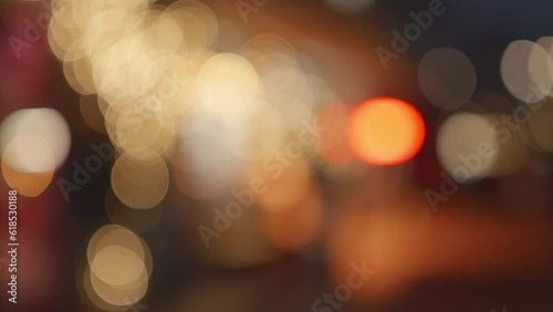 Night city view through the car front window, street lights, moving focus, bokeh effect. High quality 4k footage