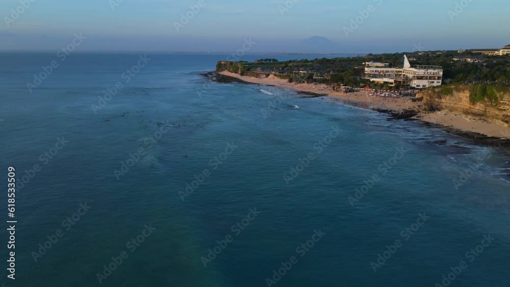 Popular holidays beach with blue ocean. Dreamland beach with sunset tones in Bali. Aerial view Popular holidays beach with blue ocean. Dreamland beach with sunset tones in Bali. Aerial view